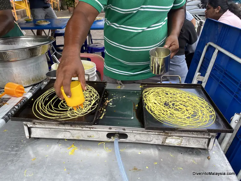 Watching roti jala being made